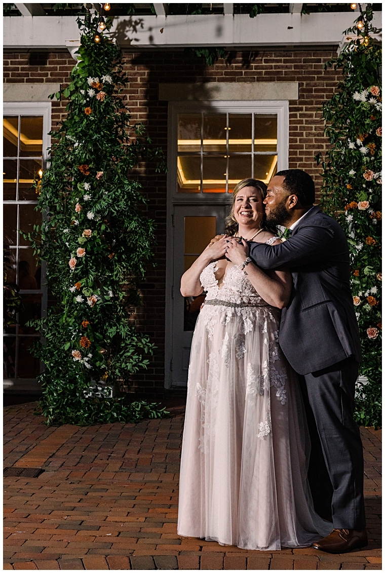 The newlyweds share a kiss under the moonlight at The Tidewater Inn