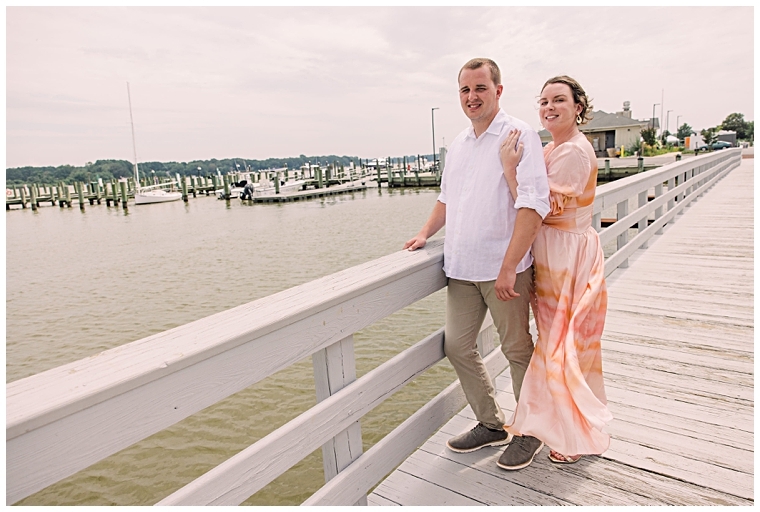 The soon to be bride and groom pose for a photo on the boardwalk | Laura's Focus Photography