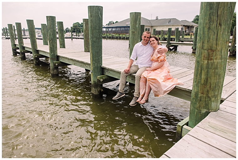 The newly betrothed couple sits on the dock enjoying the water views in Chestertown