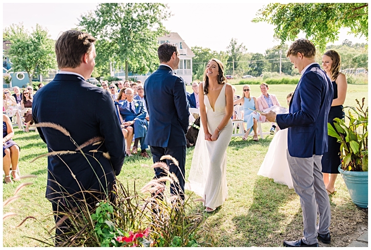 The bride and groom recite their vows on the lawn at Haven Harbour Marina Resort | Inn at Haven Harbour | Laura's Focus Photography | My Eastern Shore Wedding