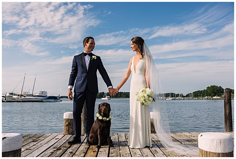The new husband and wife pose with their chocolate lab on the docks at Haven Harbour.