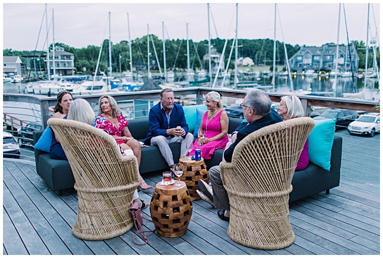 Guests enjoy the views of the sunset over the marina on the deck at the Dove and Arc Lounge at Haven Harbour Marina Resort | Inn at Haven Harbour | Laura's Focus Photography | My Eastern Shore Wedding