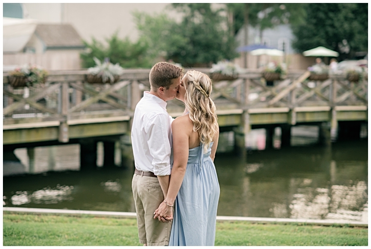 The newly engaged share a sweet kiss by the waterfront at The Chesapeake Bay Maritime Museum