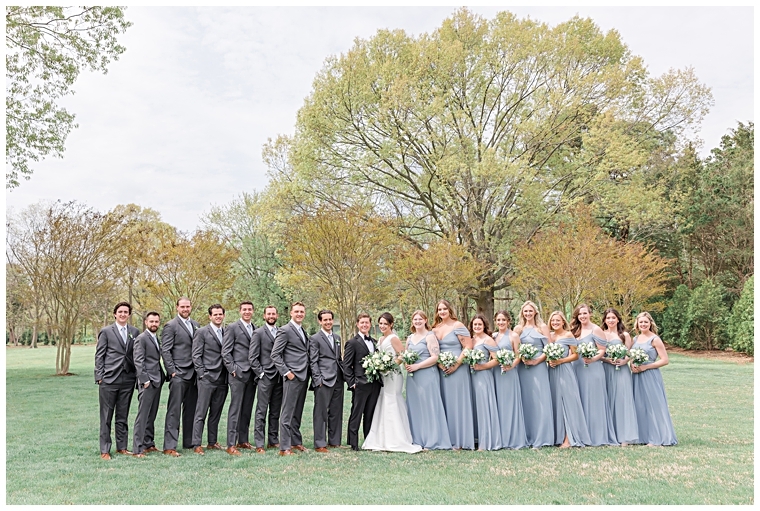 The bridal party poses for a portrait with the bride and groom