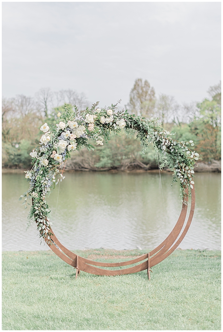 A circular archway awaits the soon to be newlyweds for their waterfront ceremony
