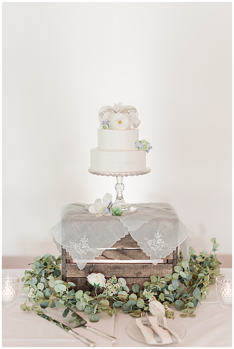 A beautiful wedding cake sits atop lace doilies