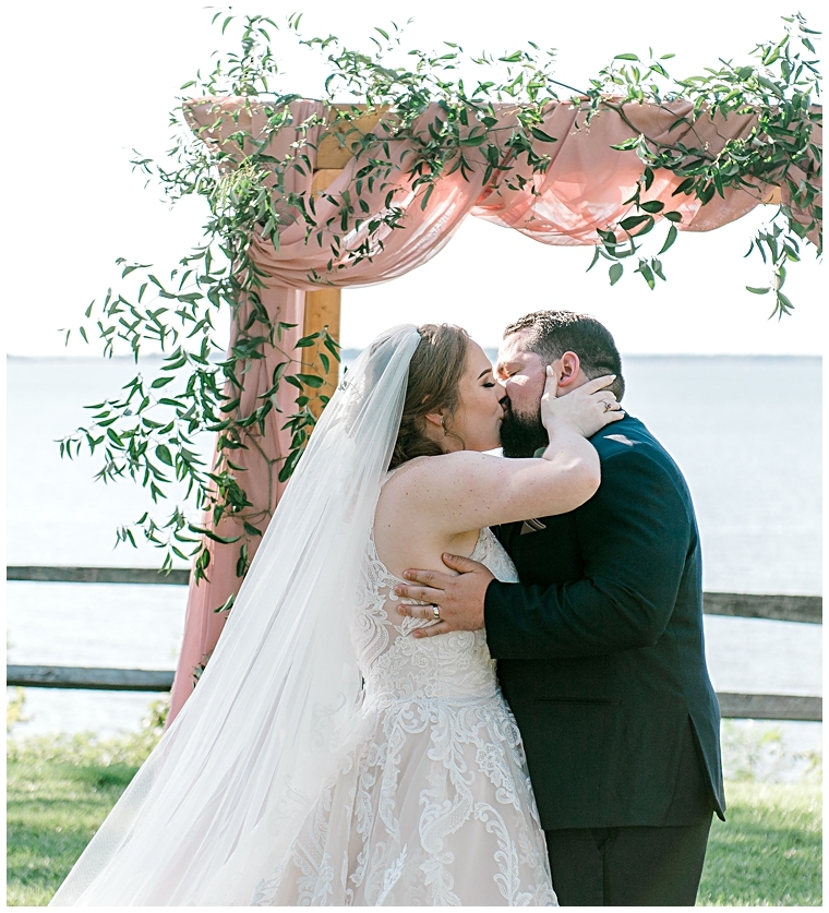 The bride and groom share their first kiss as newlyweds. | My Eastern Shore Wedding | Erin Wheeler Photography