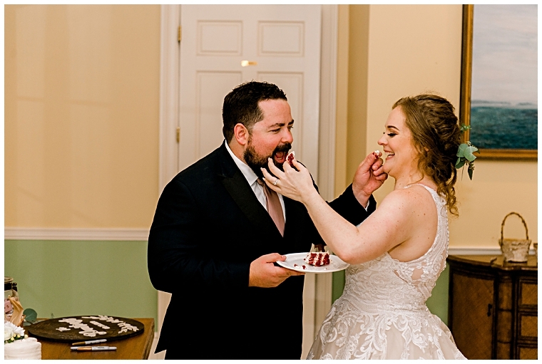 The new bride and groom feed each other the first bites of the white wedding cake | My Eastern Shore Wedding