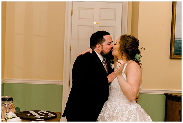 The newlyweds share a kiss after they cut their wedding cake | My Eastern Shore Wedding