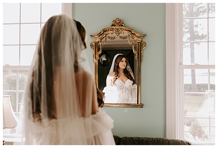 The bride has a private moment to herself while she is getting ready for the ceremony at Kingsbay Mansion