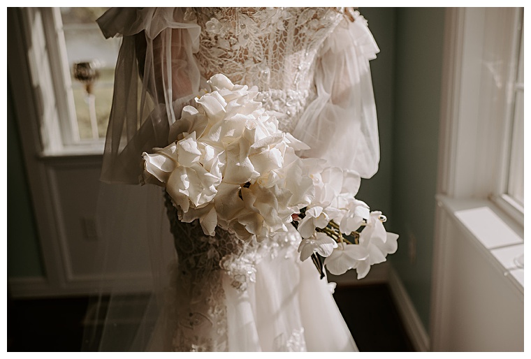 A beautiful lace gown paired with white florals for this classic bride at Kingsbay Mansion