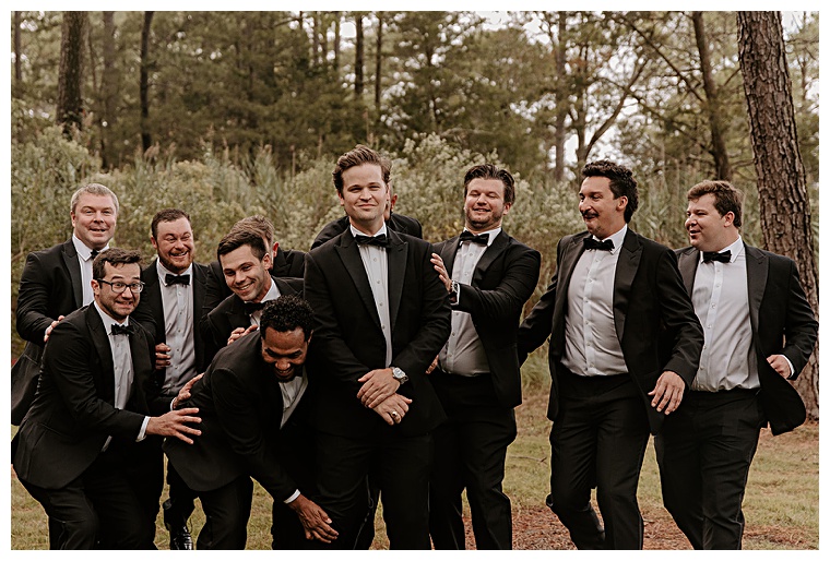Donned in classic black tuxedos these groomsmen celebrate the man of the hour with a festive pre ceremony celebration | My Eastern Shore Wedding | Kingsbay Mansion