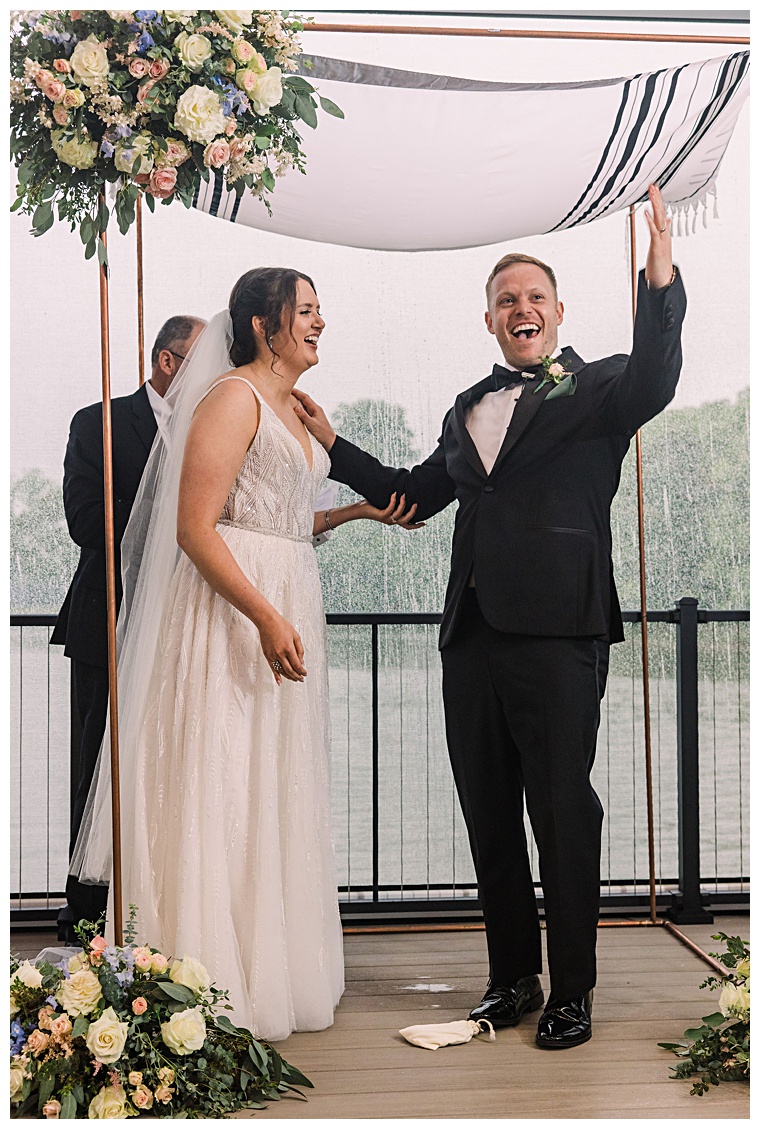 Officially married, the newlyweds celebrate at the conclusion of their waterfront ceremony on the pier at The Oaks | Laura's Focus Photography | My Eastern Shore Wedding