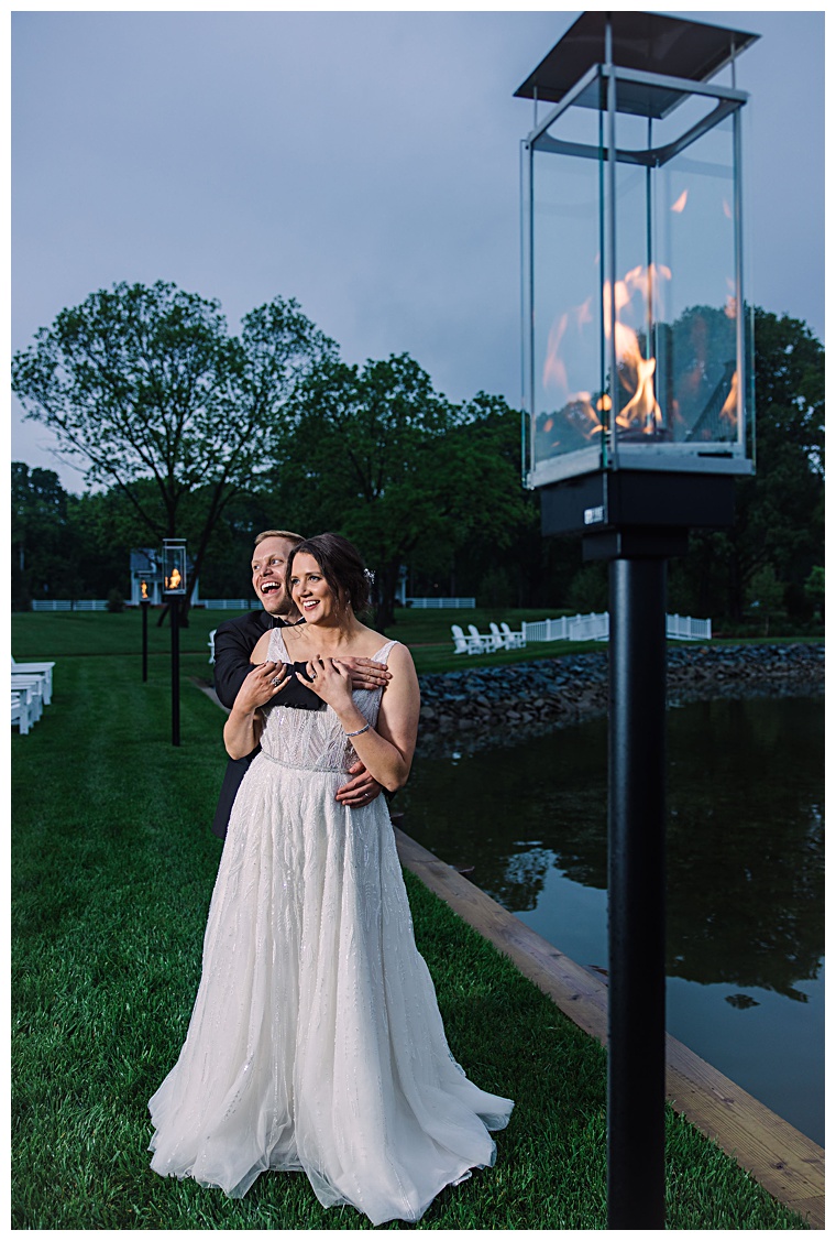 The new husband and wife share a private moment by the waterfront at The Oaks Hotel during their reception | Laura's Focus Photography | My Eastern Shore Wedding