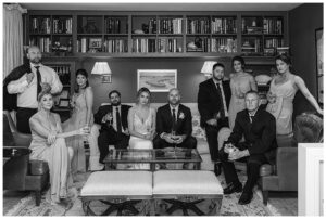 The bridal party poses for a moody portrait in the library
