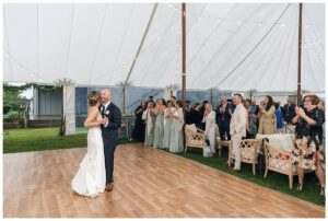 The newlyweds enjoy their first dance as husband and wife in a beautiful tent with a dance floor by Eastern Shore Tents and Events | My Eastern Shore Wedding