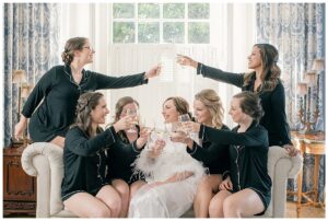 Cheers to the newlyweds! The bridesmaids pop the champagne in celebration of the newlyweds.