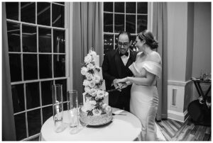The bride and groom cut their wedding cake together