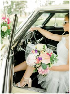A sassy bride takes the wheel in this boldly colored styled shoot featuring Three Little Buds