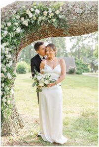 Florals by Three Little Buds frame the portrait of the bride and groom