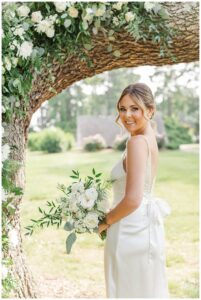 A floral backdrop by Three Little Buds florals matches the bridal bouquet perfectly.