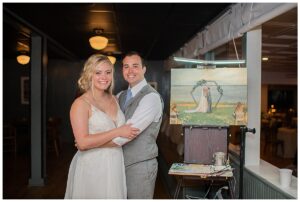The newlyweds get a first look at their live wedding portrait
