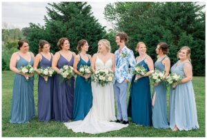 Surrounded by her best friends, the bride poses for a beautiful portrait with hues of blues.