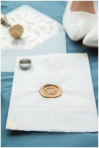 The invitation suite is styled for a detail photography with the wedding rings