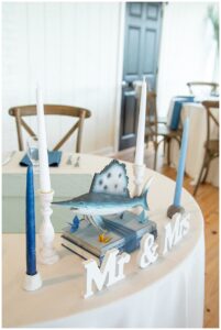 The sweetheart table is decorated with soft blues and whites.