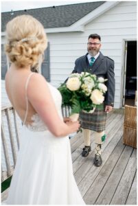 The father of the bride gets a first glimpse at his daughter before he walks her down the aisle to her future husband