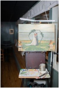 A live painting of the wedding ceremony is on display during the reception.