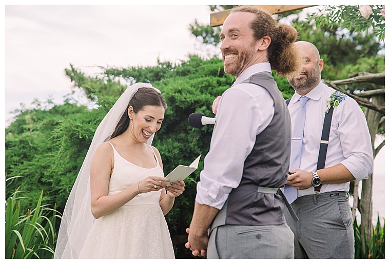 It's all smiles as this bride reads her vows to her groom at Black Walnut Point Inn | Laura's Focus Photography