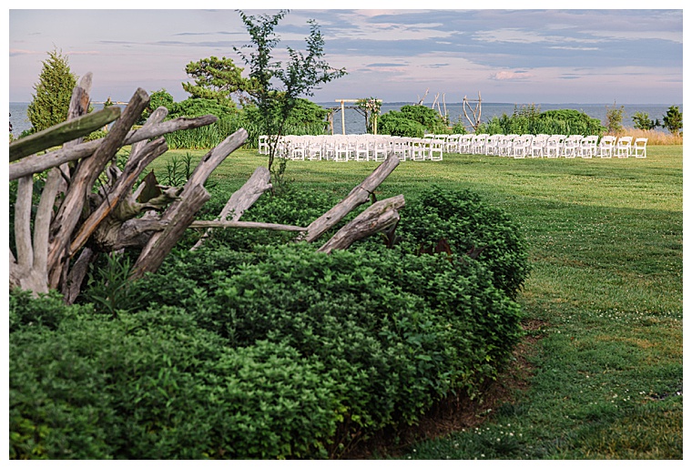 The ceremony site sits on the waterfront at Black Walnut Point Inn | Laura's Focus Photography