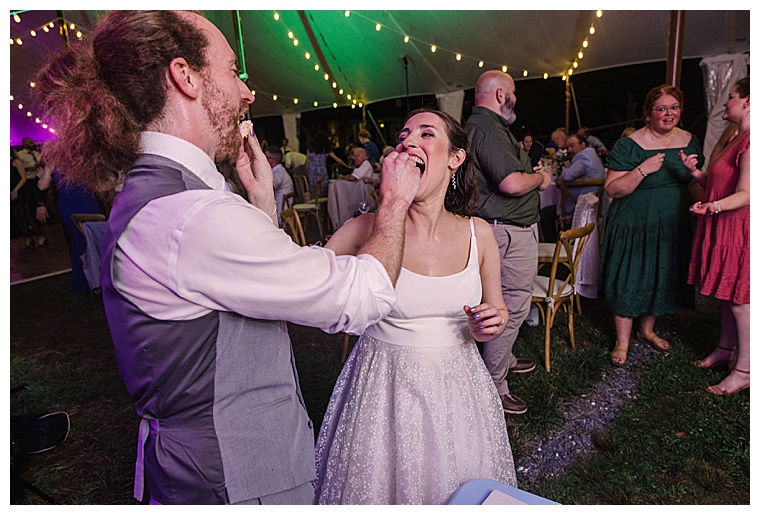The bride and groom share the first piece of their delicious wedding cake at Black Walnut Point Inn | Laura's Focus Photography