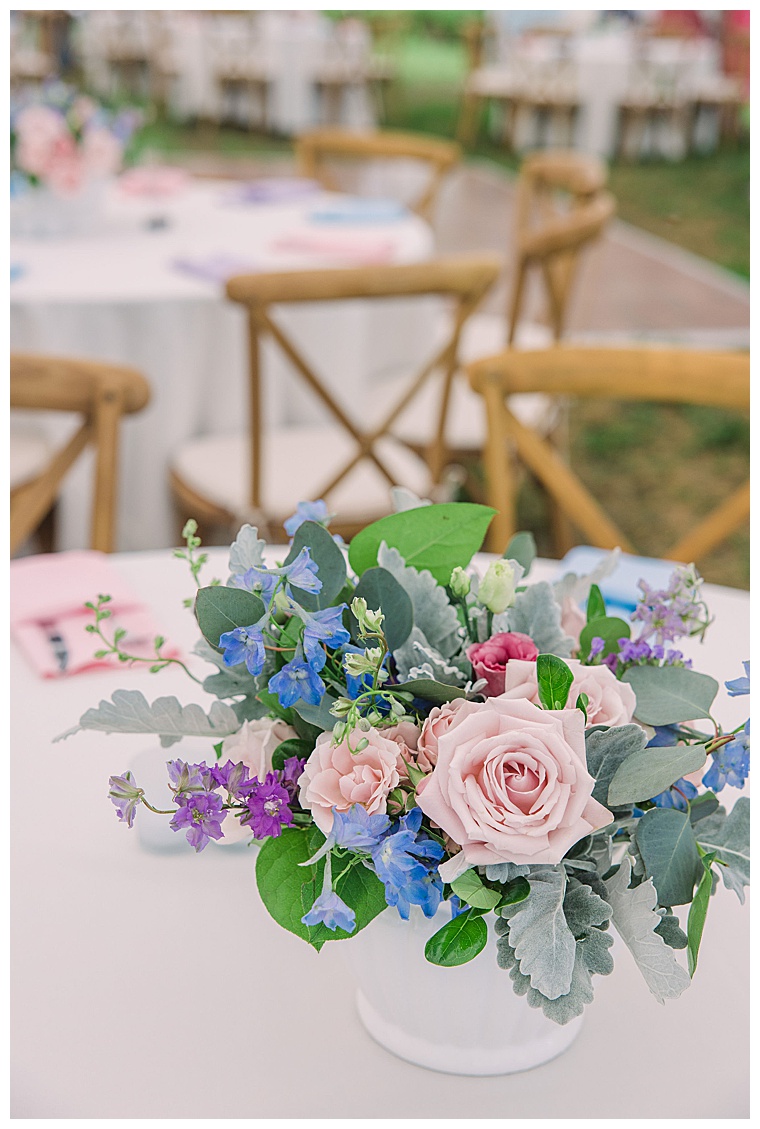 Blue, purple, and pink florals mixed with greenery make the most beautiful centerpieces for this colorful reception