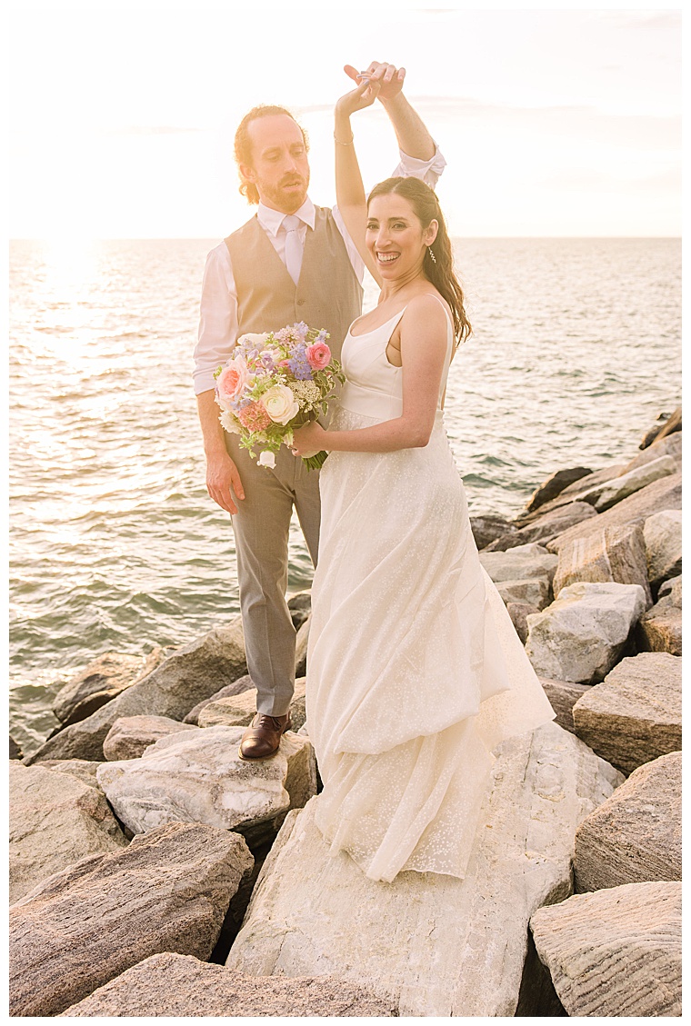 The bride and groom dance in the sunset on the waterfront at Black Walnut Point Inn | Laura's Focus Photography