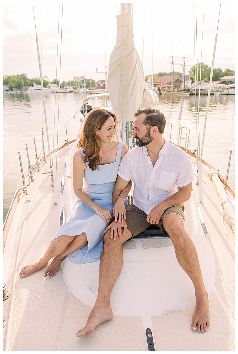 The soon to be newlyweds enjoy the waterfront at the Chesapeake Bay Maritime Museum on the bow of a beautiful sail yacht.