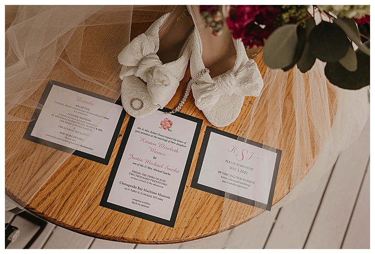 The invitation suite is staged with the bridal jewelry and shoes for a detail portrait