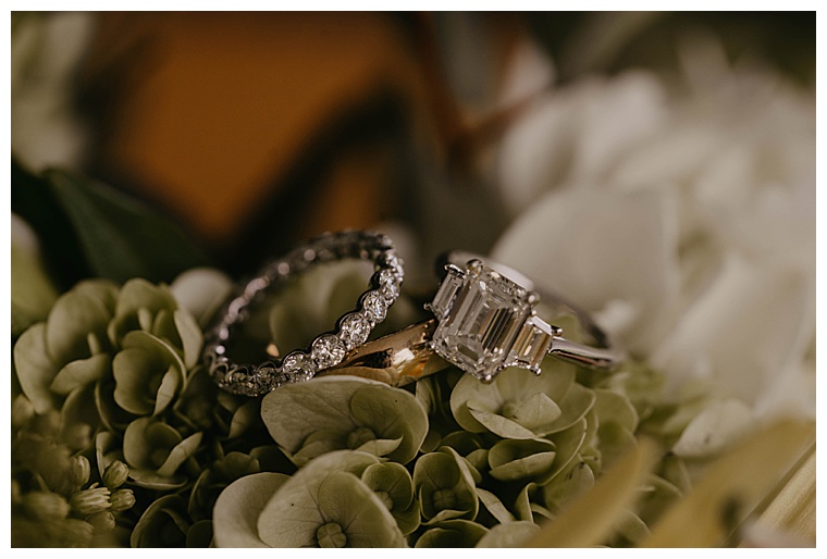 wedding bands rest on the florals for a ring portrait