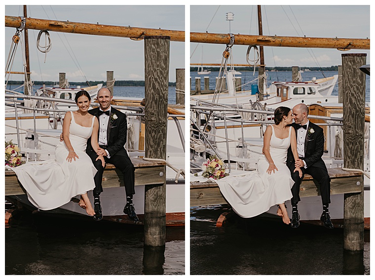 The bride and groom sit on the dock and watch the water at the Chesapeake Bay Maritime Museum
