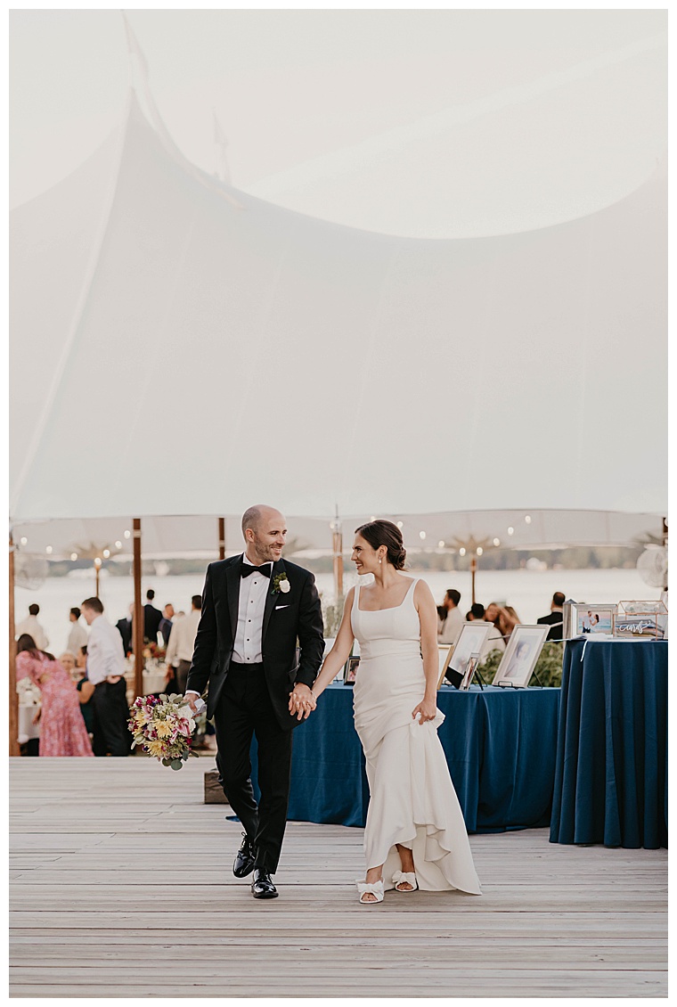 The bride and groom walk the grounds at the Chesapeake Bay Maritime Museum as newlyweds as their guests make their way to the reception tent.