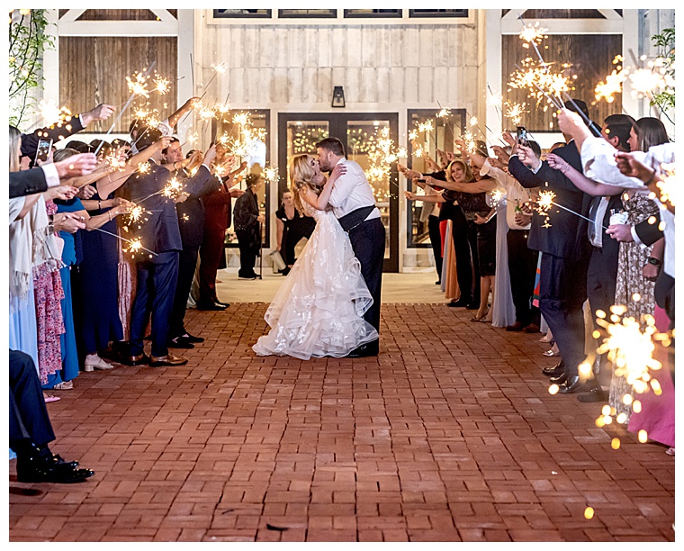 The newlyweds leave their reception through a stunning sparkler tunnel as they get ready to depart for their honeymoon in the most magical sendoff ever.
