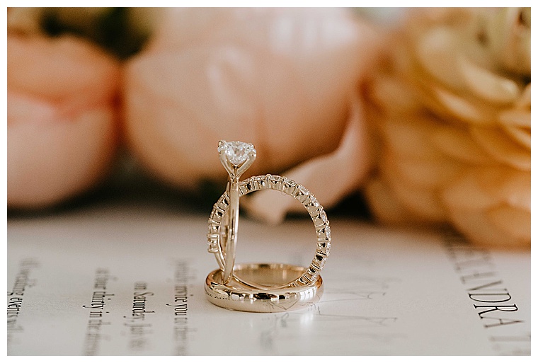 Gold wedding bands match the bride's stunning engagement ring
