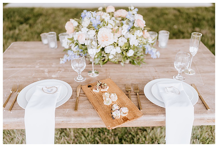 A sweethearts' table for the bride and groom is decorated with stunning roses and a private selection of appetizers for the newlyweds to enjoy