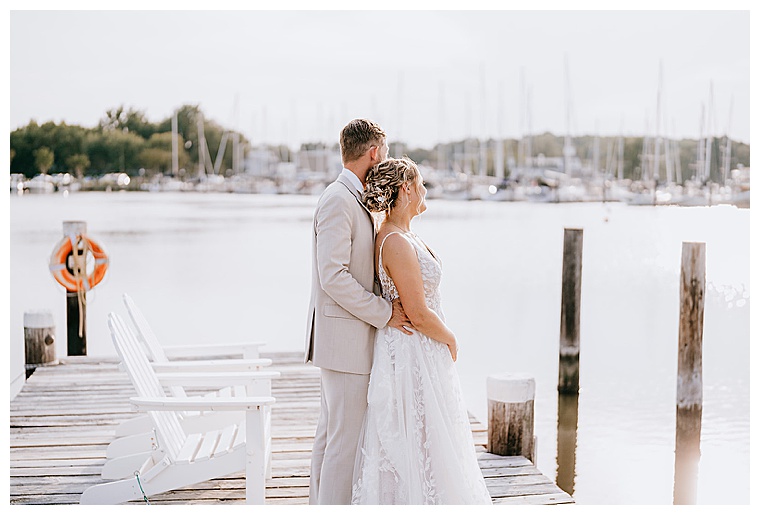 On the dock at the Inn at Haven Harbour the newlyweds enjoy a private moment together during the sunset.
