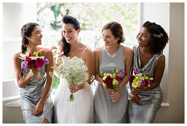 Sparkling in silver, these bridesmaids have a different style dress to fit their shining personalities as they help the bride get ready for her big day.