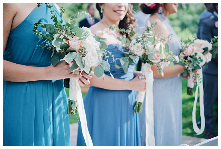 A variety of blue bridesmaids dresses with different styles and colors highlight these bridesmaids beautifully.