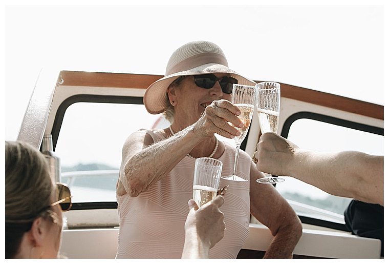 Guests toast to the newlyweds as they set underway for a sailboat ceremony on the Eastern Shore of MD