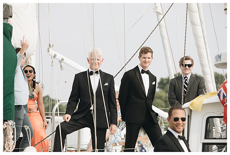 Family and friends board the fleet of sailboats to witness the exchanging of vows