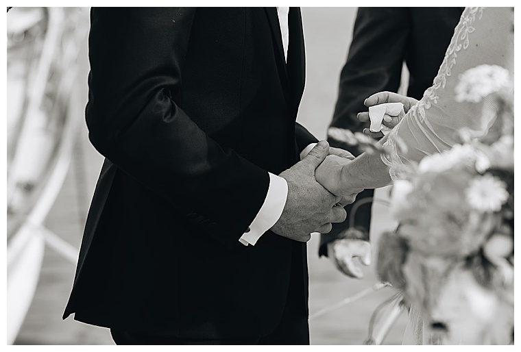 The bride and groom embrace in holding hands as they exchange their romantic wedding vows